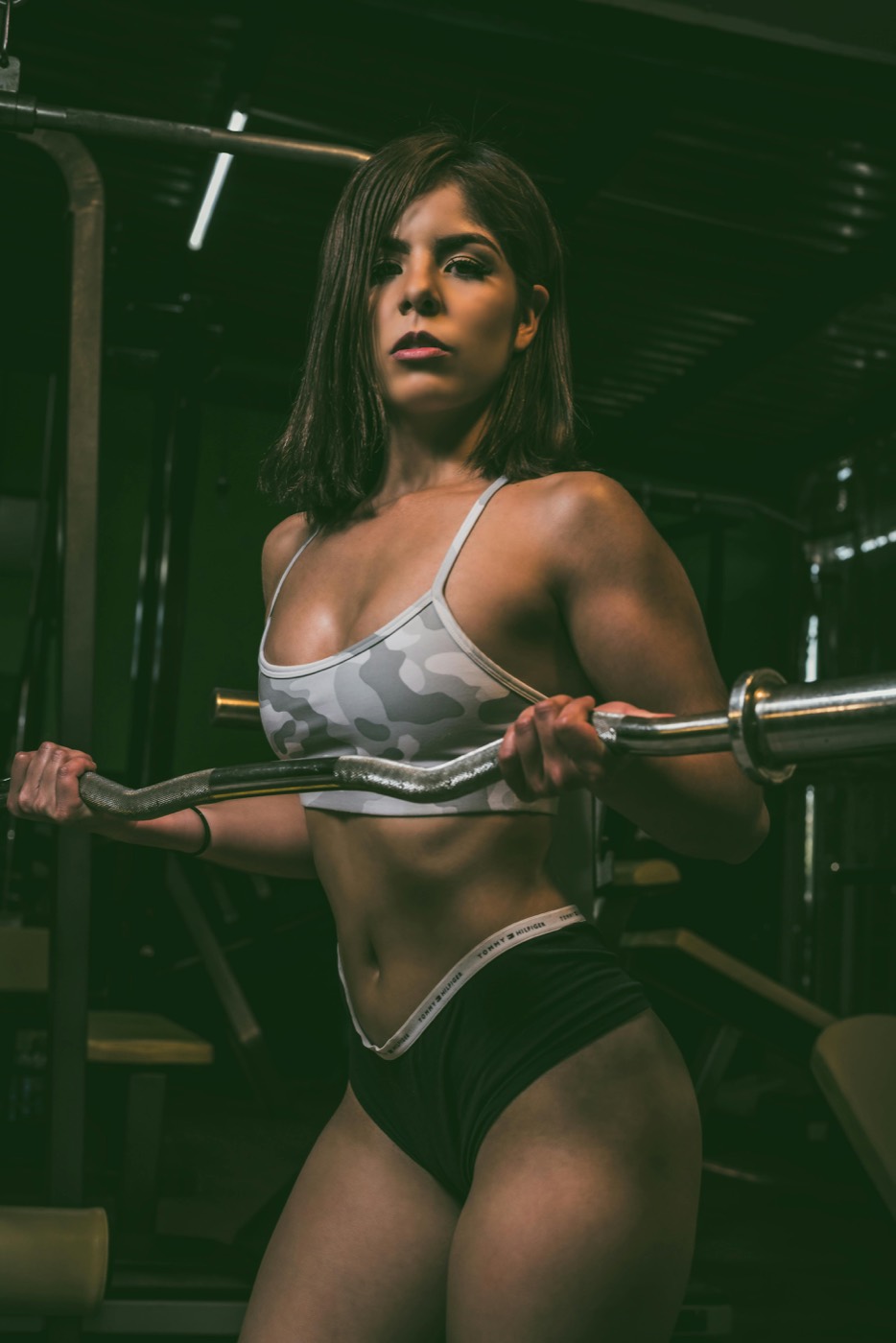 A member training with a curl bar